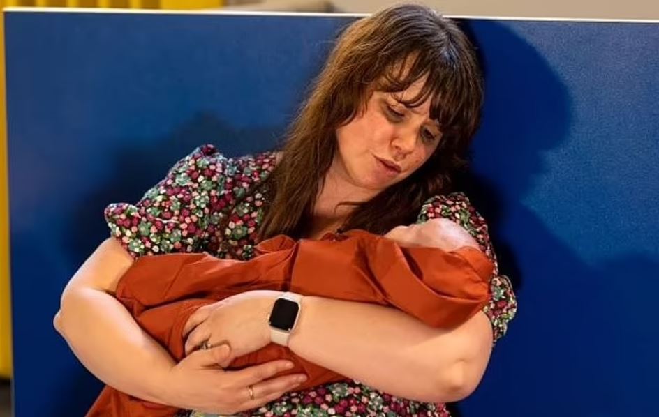 A woman holding a baby in her arms.