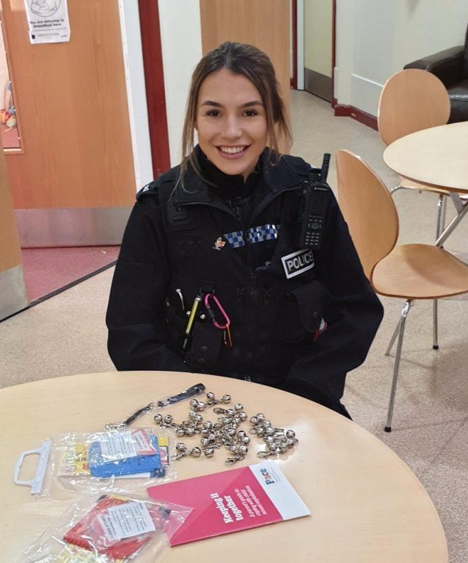 Police officer with safety bells and pamphlets.