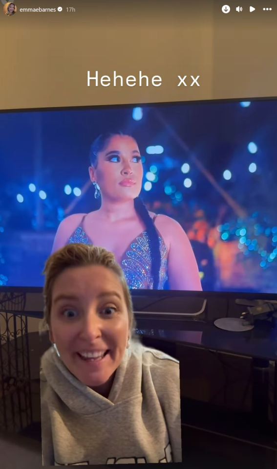 Screenshot of a woman reacting to a TV show featuring another woman in a sparkly dress.