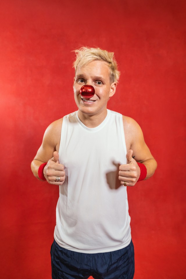 Jamie Laing with a red nose, giving thumbs up.