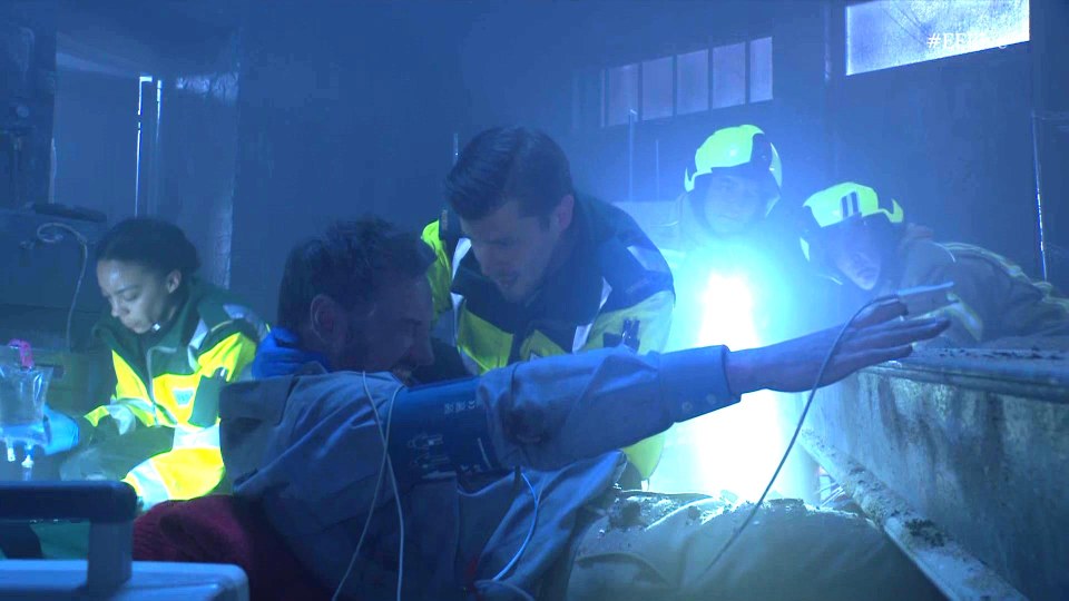 Paramedics attending to an injured man.