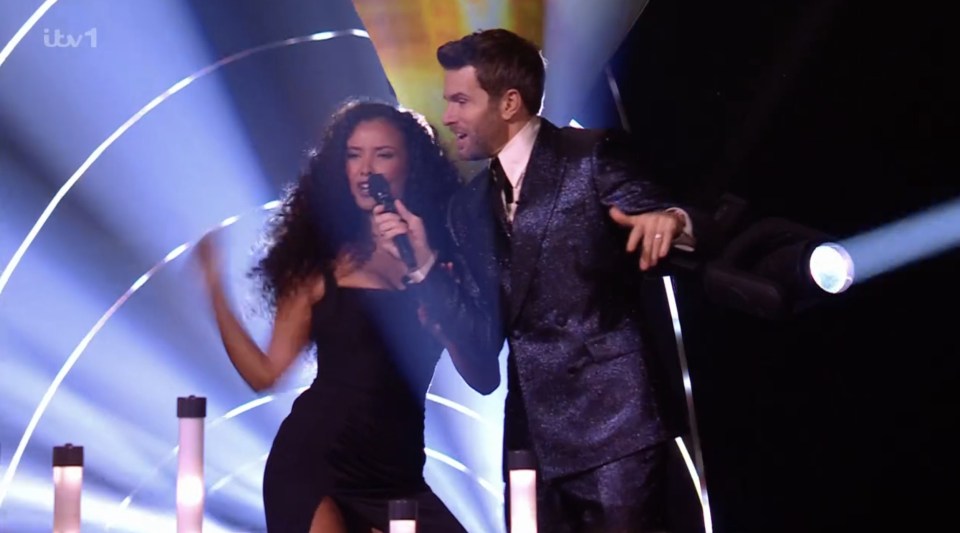 Two singers performing on stage.