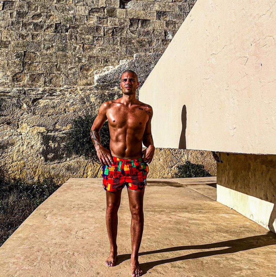 Max George in patterned swim shorts.