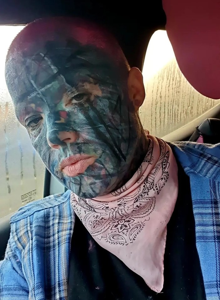 Close-up of Melissa Sloan, a heavily tattooed woman, wearing a baseball cap and plaid shirt.