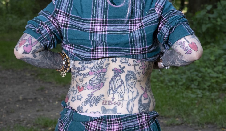 Woman with extensive tattoos on her arms and torso.