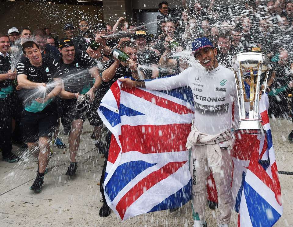Lewis Hamilton celebrates a Formula One victory with his team.