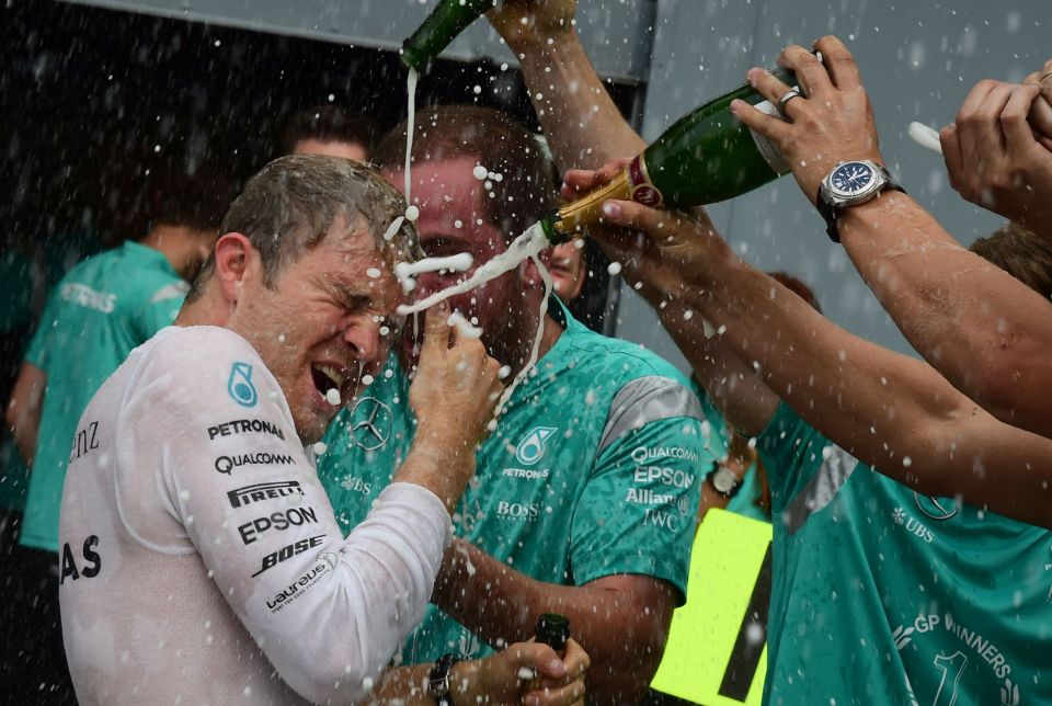 Formula One driver Nico Rosberg being sprayed with champagne after winning a race.