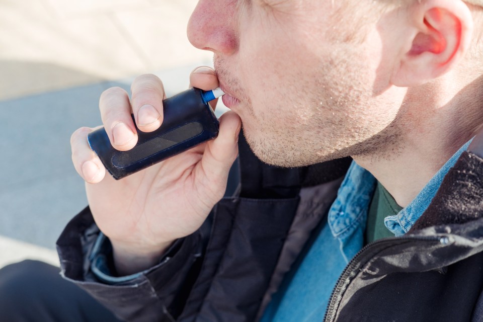Man vaping an electronic cigarette.