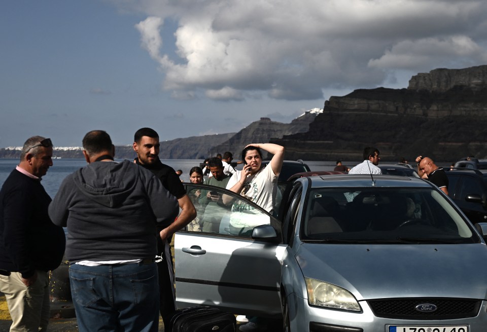 People waiting at a ferry terminal in Santorini, Greece, after a series of earthquakes.
