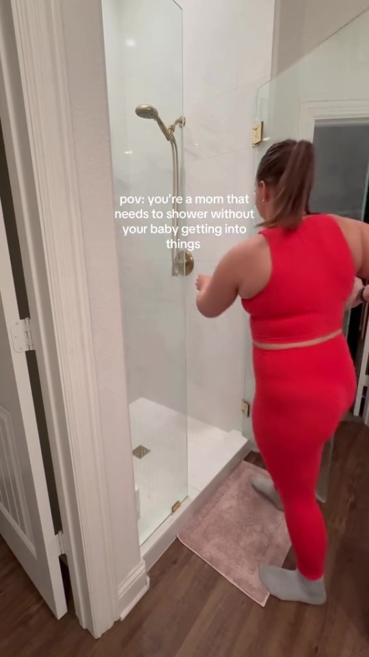 Mom showering while keeping baby out of the way.