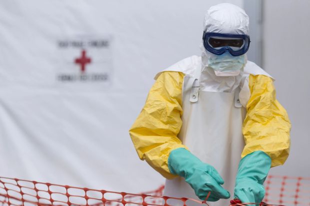 An image collage containing 1 images, Image 1 shows Health worker in protective gear at an Ebola treatment center