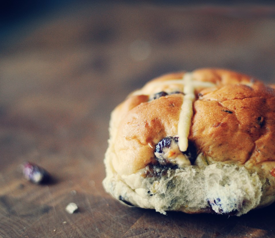 Hot cross bun on a dark background.