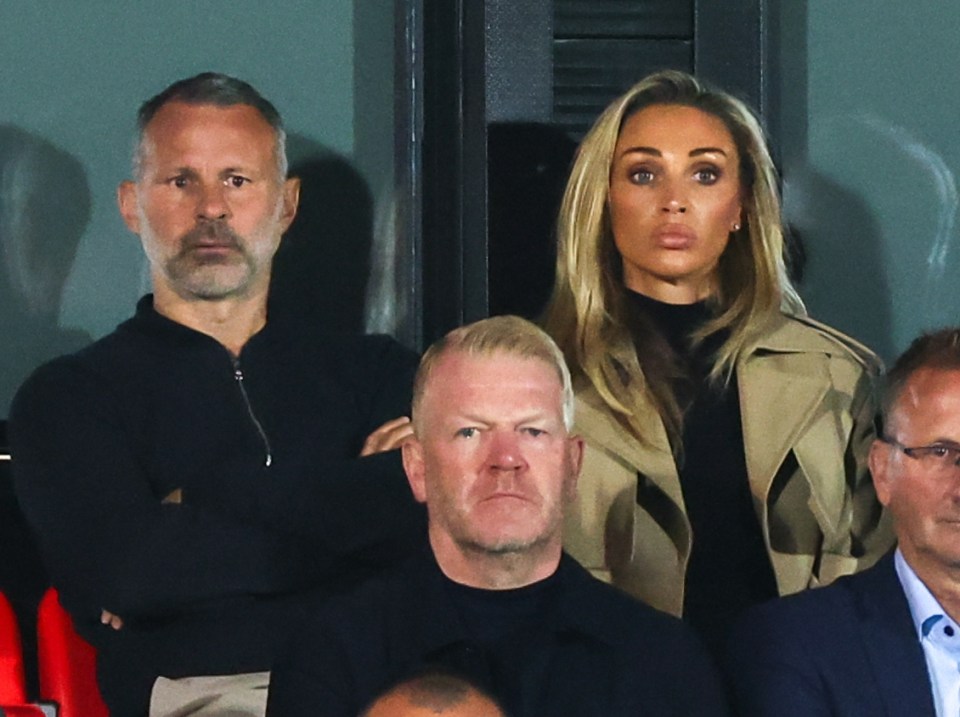Roy Keane, Nicky Butt, and Ryan Giggs, part-owners of Salford City, at a football match.