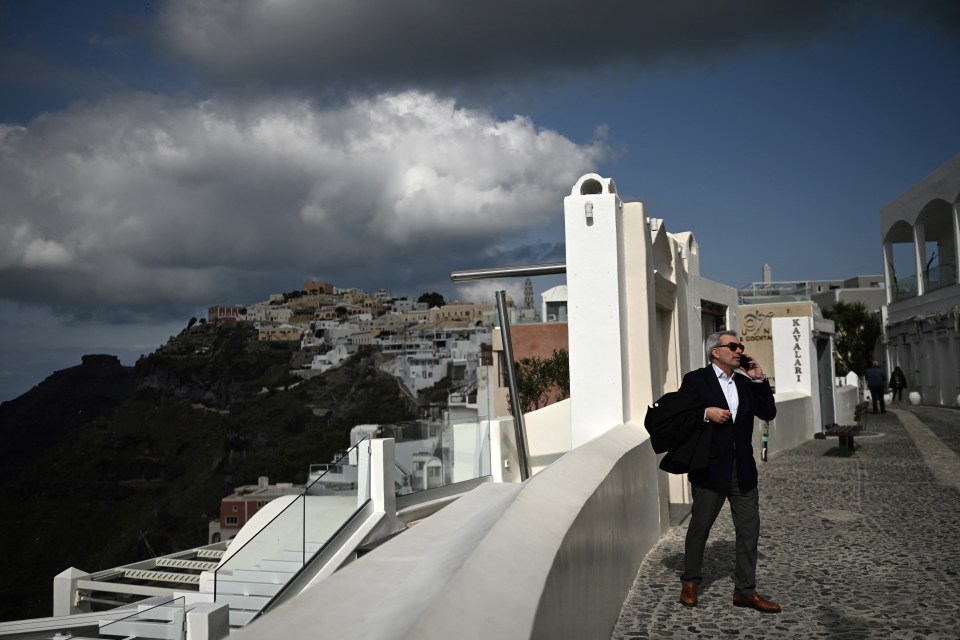 Man on Santorini using a cell phone.