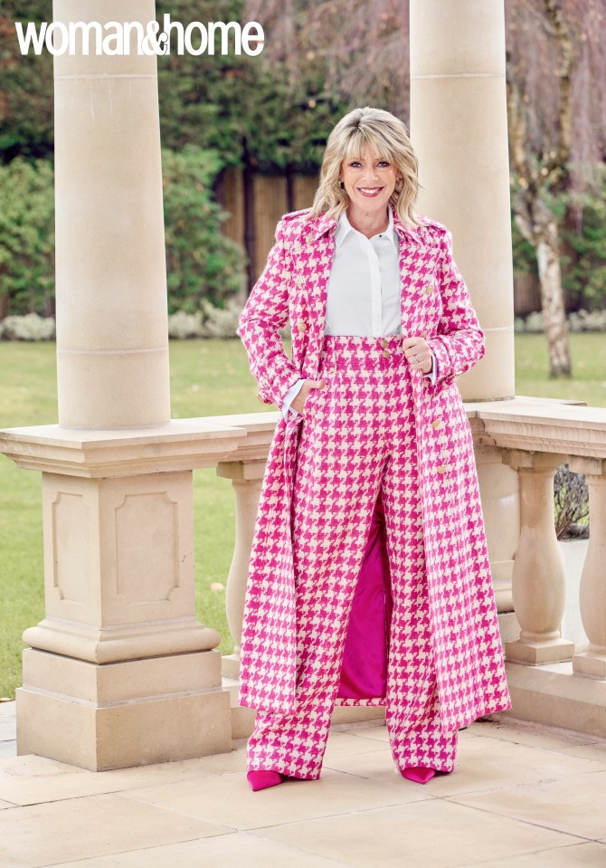 Woman in pink houndstooth suit and coat.