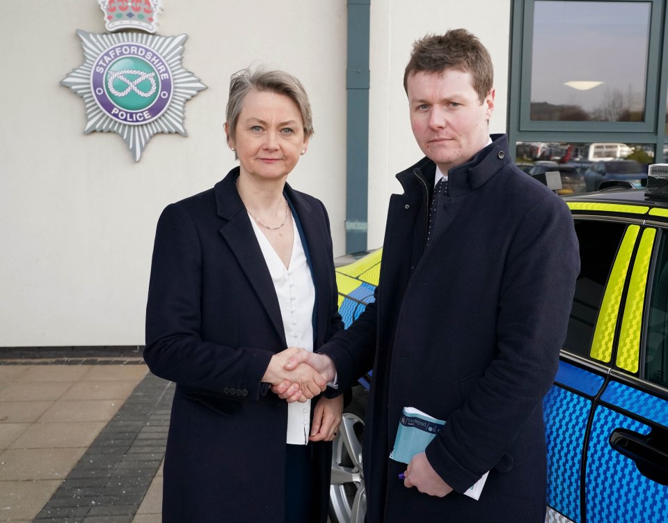 Yvette Cooper, Home Secretary, shaking hands with a man in front of Staffordshire Police HQ.