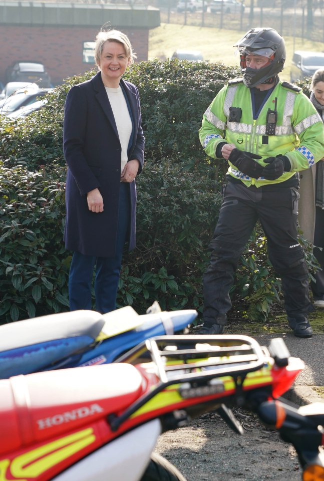 Home Secretary Yvette Cooper speaking with a police officer at Staffordshire Police HQ.