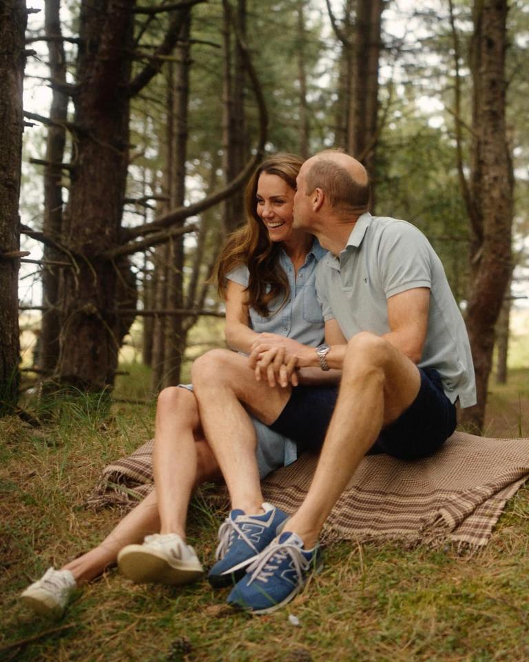 Prince William and Kate Middleton sitting together in a forest.