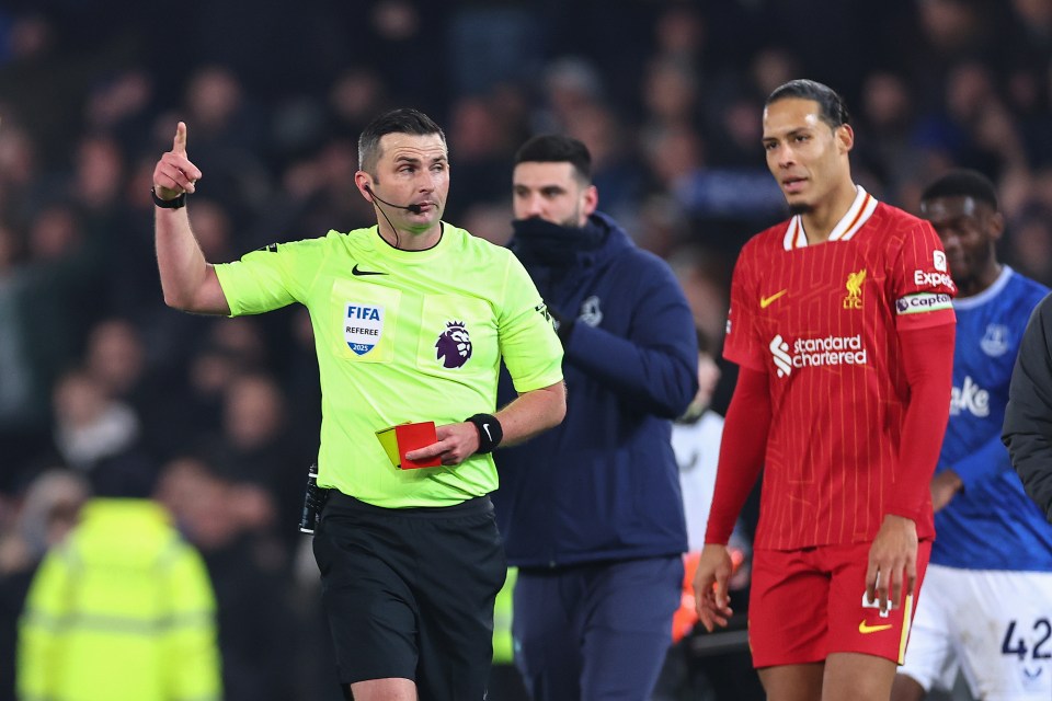 Referee showing a red card to a soccer player.