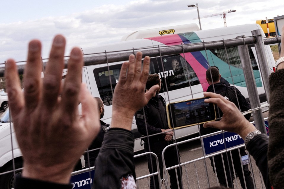 Released hostage Eli Sharabi seen reacting from a van.
