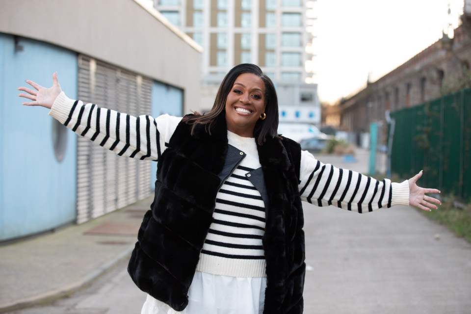 Alison Hammond smiling with arms outstretched.