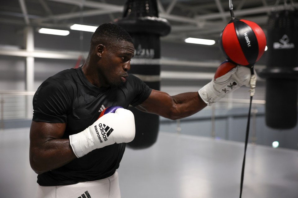 Boxer Richard Riakporhe training with a speed bag.