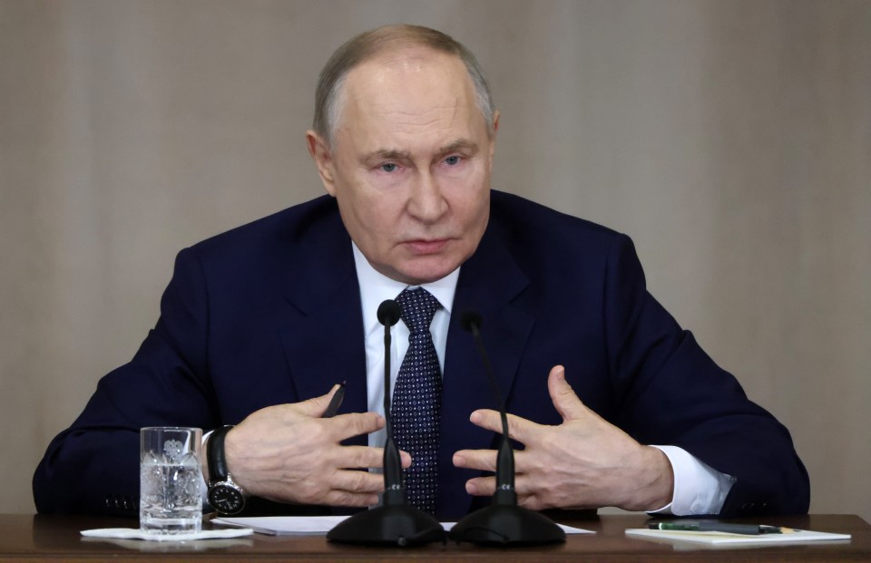 Vladimir Putin speaking at a podium.