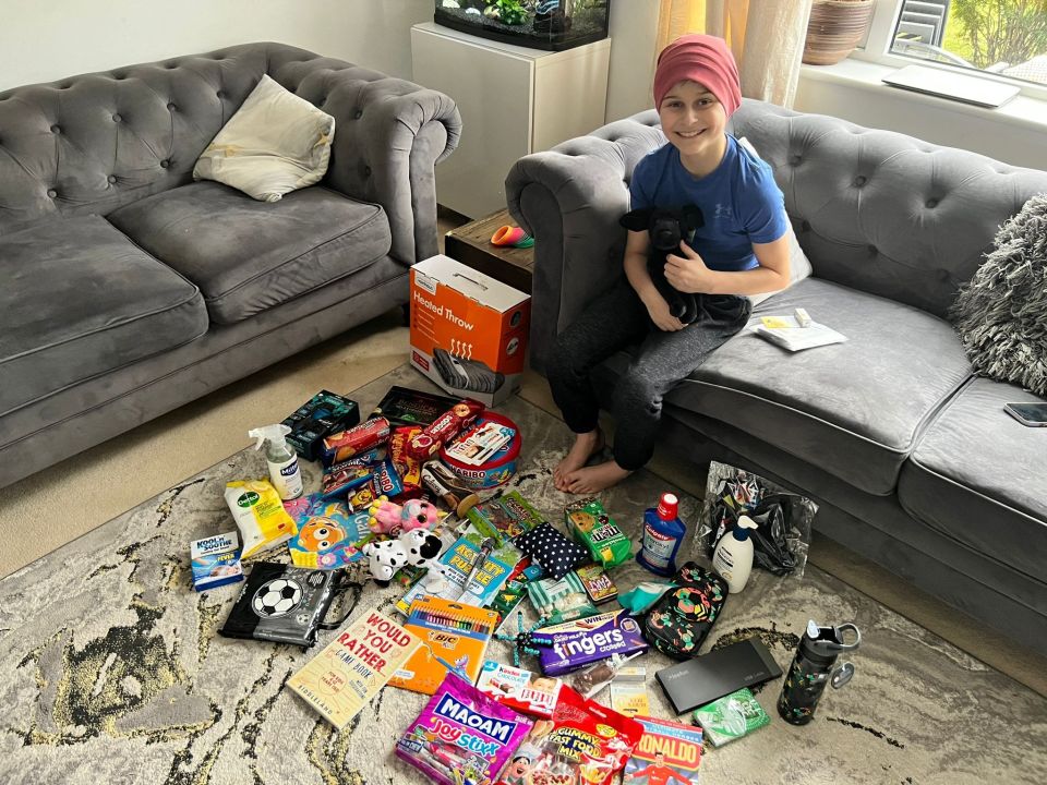 Boy with his dog and a large collection of gifts.