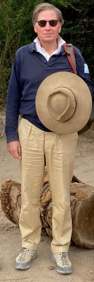 Piers Litherland, archaeologist, standing near a log.
