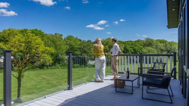 Couple enjoying a view from a deck.