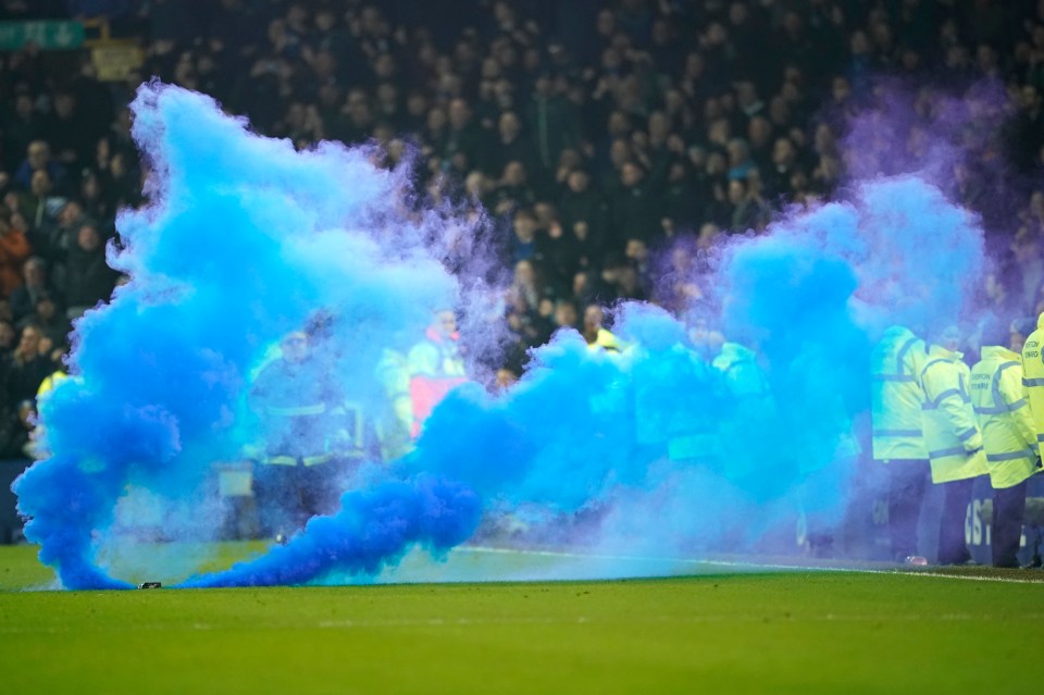 Blue smoke flare at a soccer match.