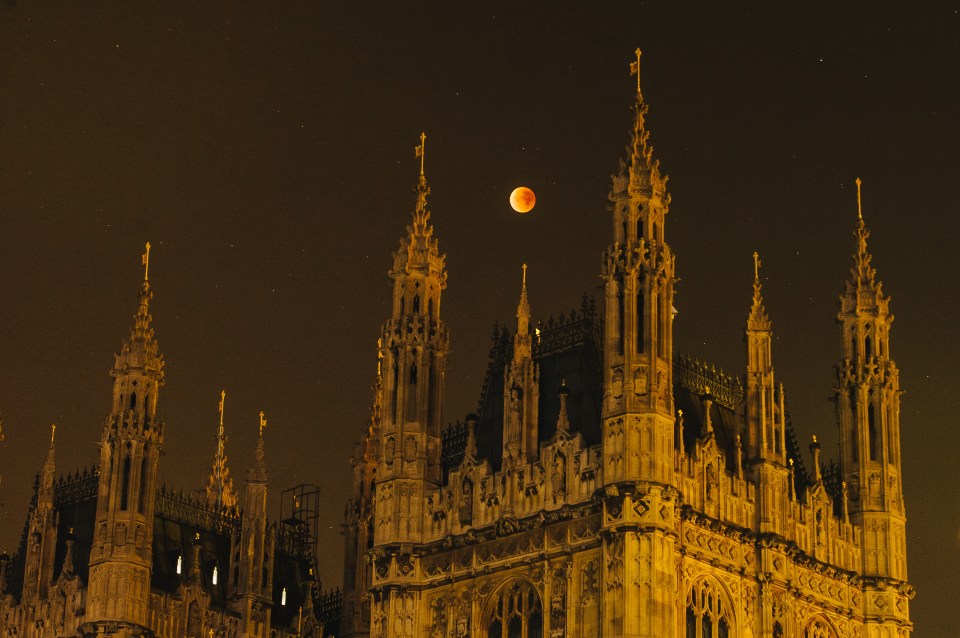 Super blood moon rising over the spires of the Houses of Parliament.