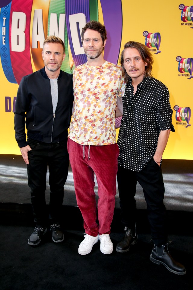 Gary Barlow, Howard Donald, and Mark Owen of Take That at a photo call.