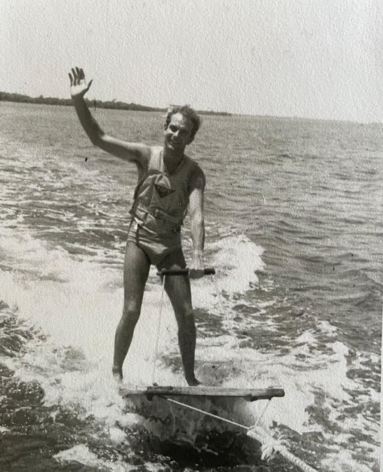 Black and white photo of a man waterskiing.