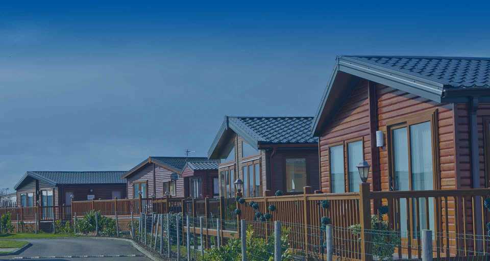 Row of wooden cabins at WhiteHouse Leisure Park.