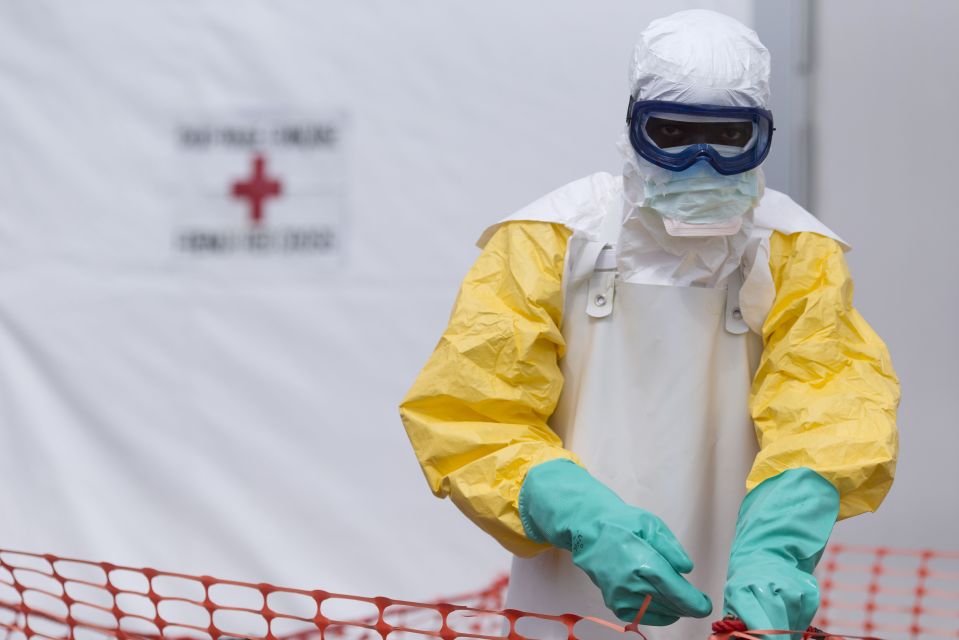 Health worker in protective gear at an Ebola treatment center.