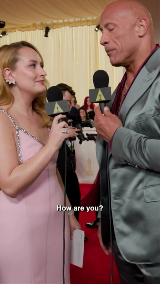 Amelia Dimoldenberg interviewing Dwayne "The Rock" Johnson on the Oscars red carpet.