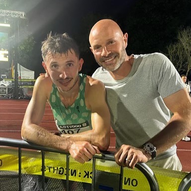 Two men posing for a photo after a race.