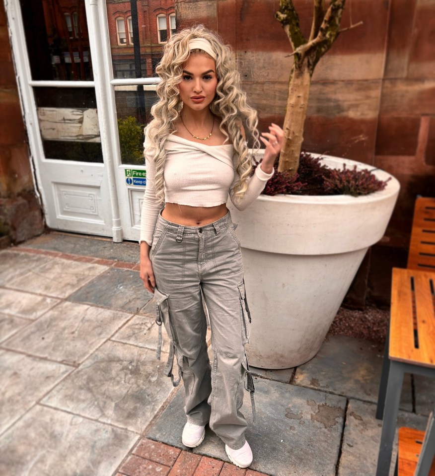 Woman in beige top and gray cargo pants.