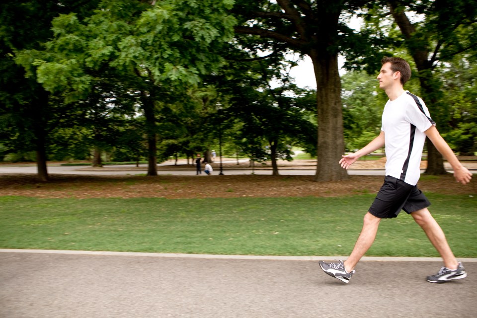 Man power walking in a park.