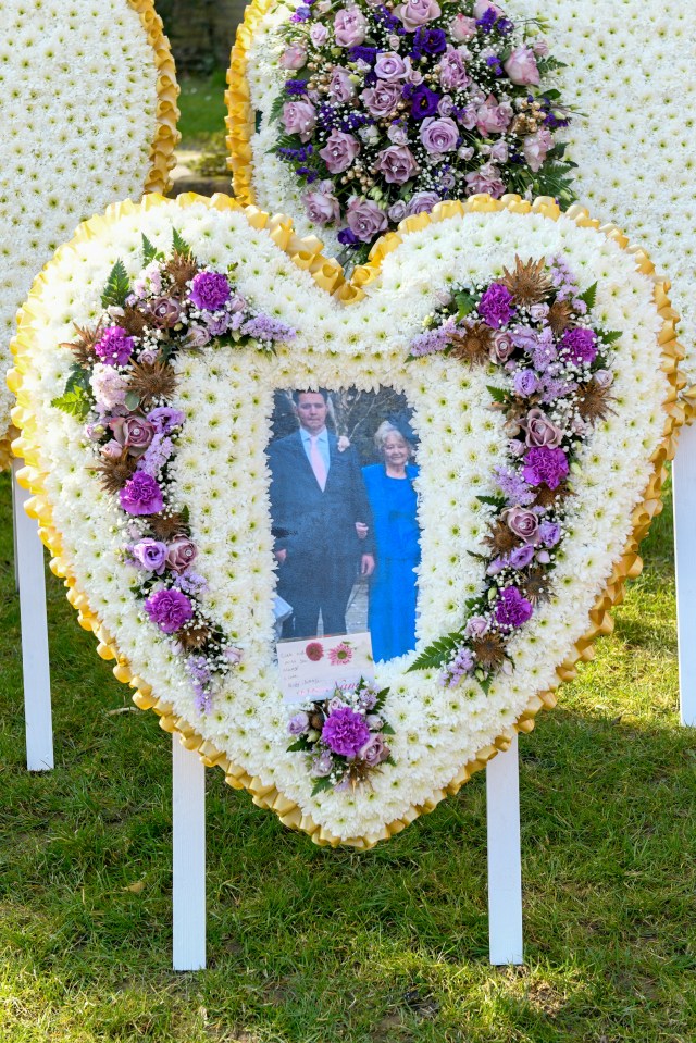 Heart-shaped funeral wreath with a photo of a couple.