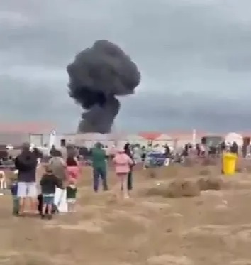 Smoke plume from a plane crash at an air show.