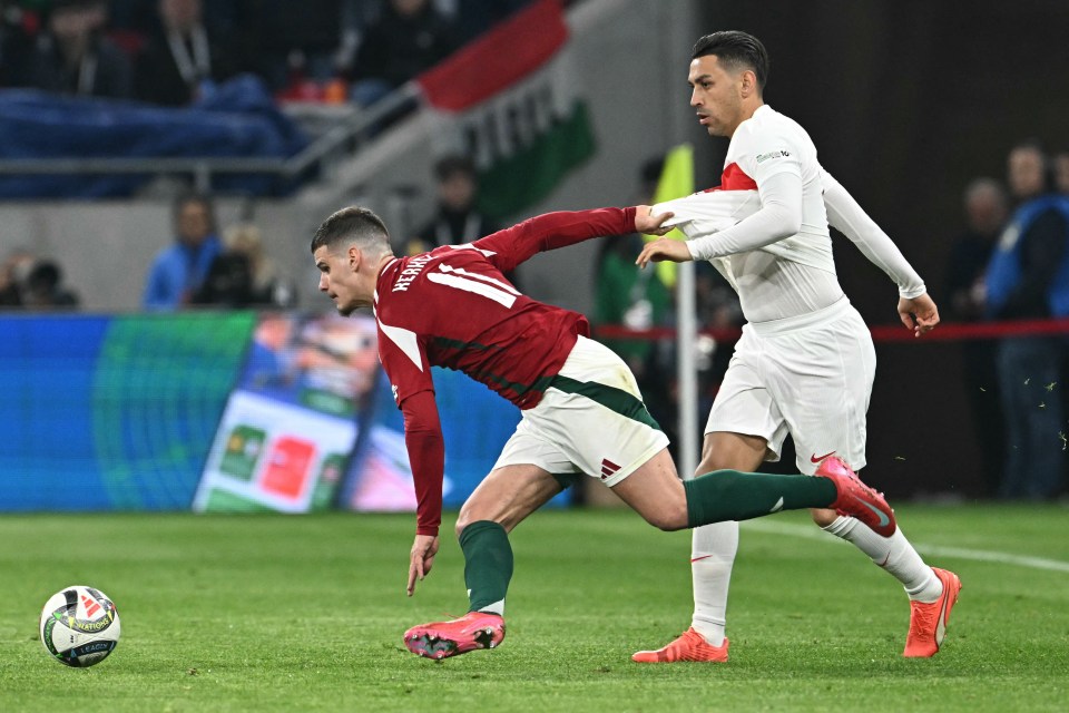 Hungary's Kerkez and Turkey's Kahveci vie for the ball.