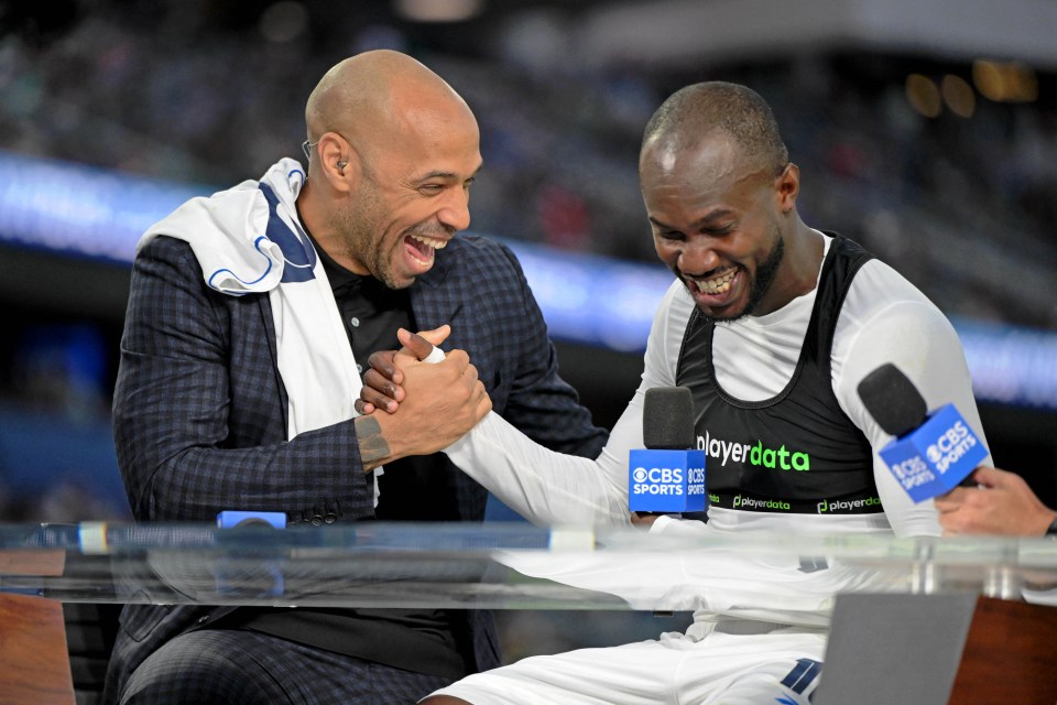 Thierry Henry and Cecilio Waterman laughing and shaking hands during a post-game interview.