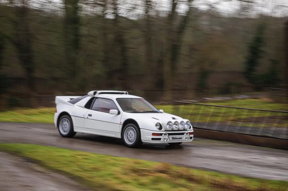 White Ford RS200 S driving on a road.