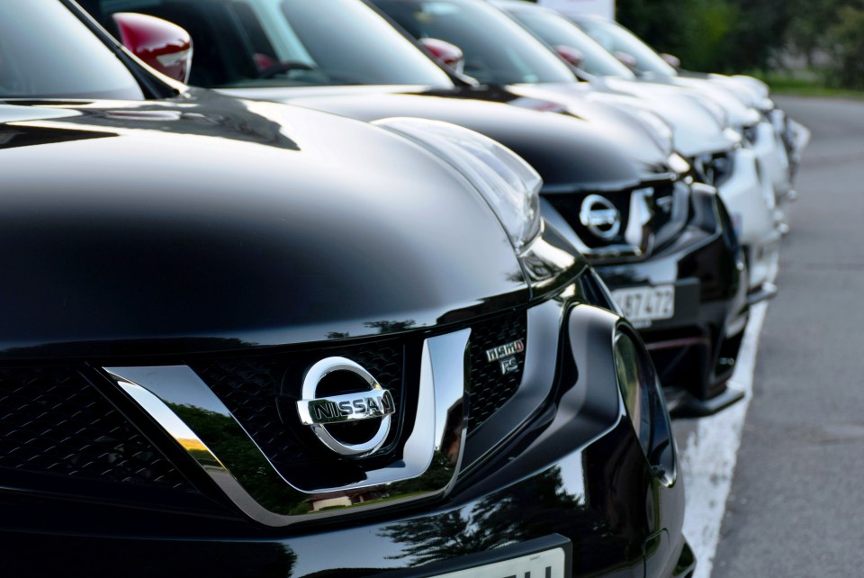 Row of Nissan Juke cars parked in a lot.