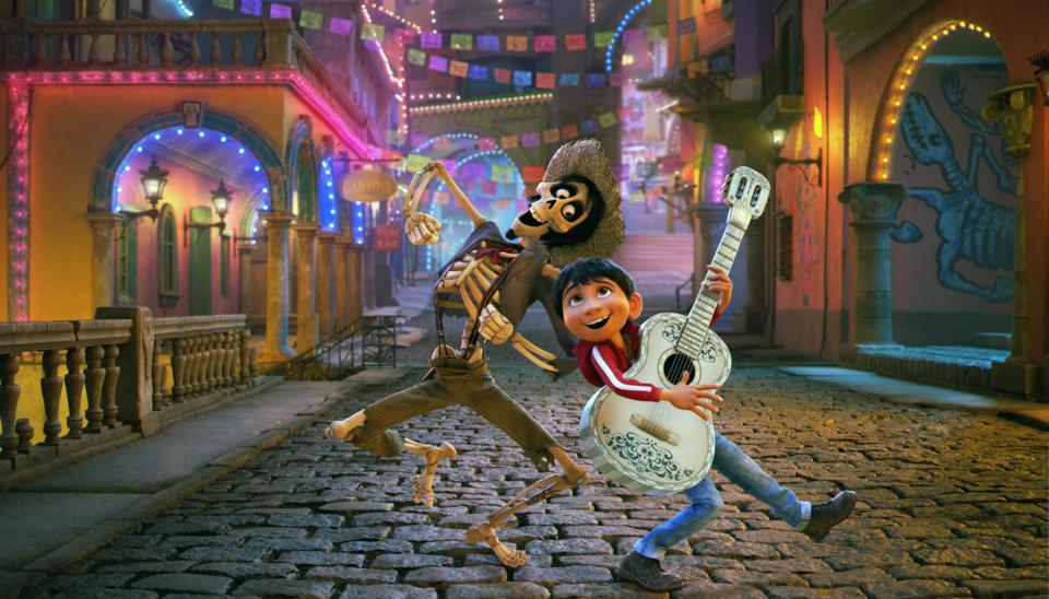 Illustration of Miguel and Héctor from Coco playing music in a cobblestone street.