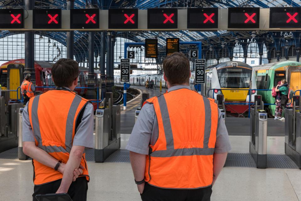 Railway station staff monitoring cancelled trains.