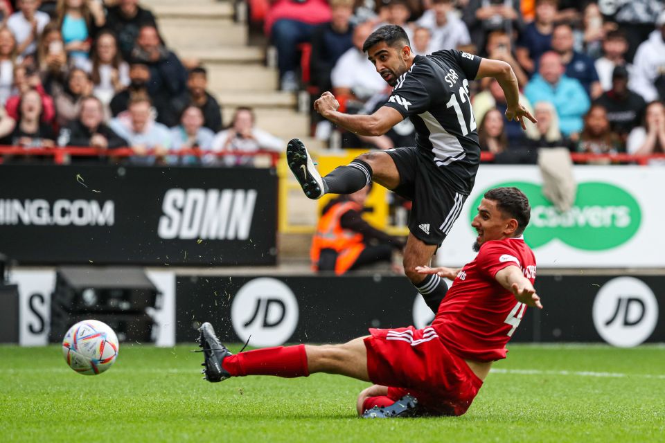 Sidemen FC player kicking a soccer ball during a charity match.