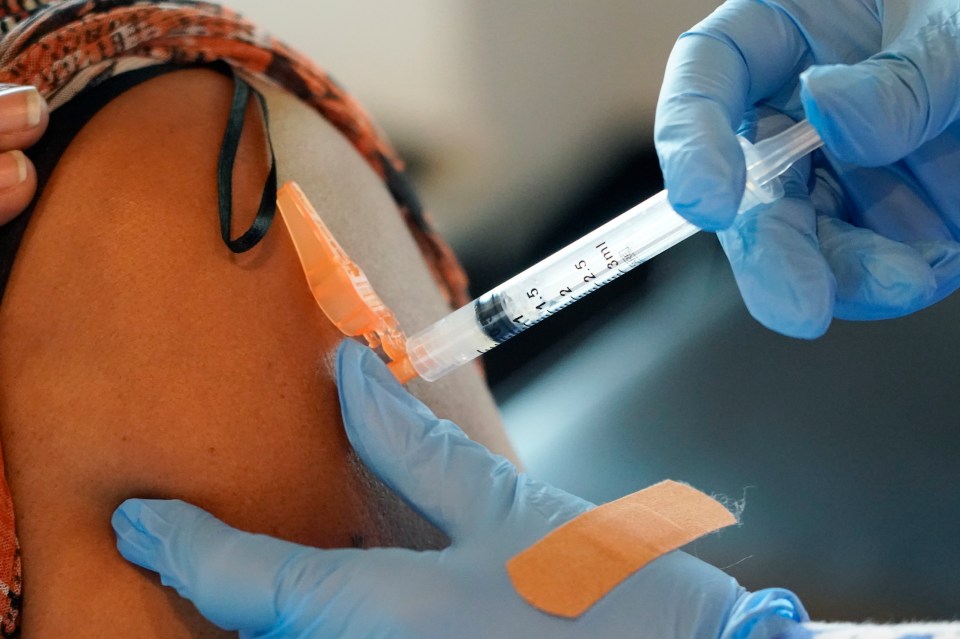 A person receiving a COVID-19 vaccination.